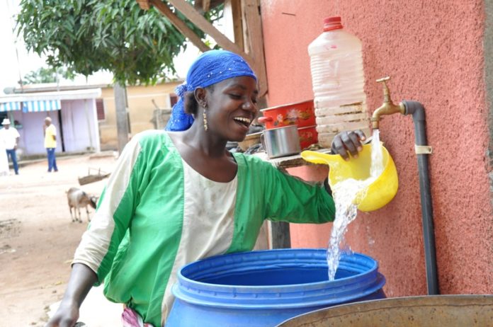 Une habitante de Gbémazo recueillant de l'eau au robinet (2)